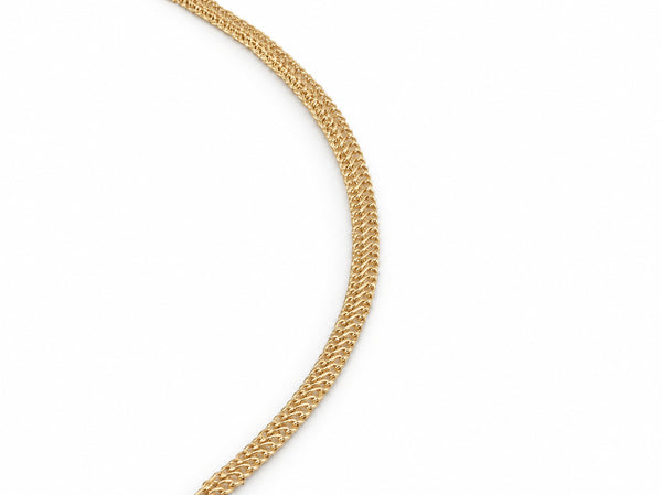 Close-up detail of the woven chevron link pattern on the gold chain necklace