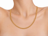 Woven gold chain necklace worn on the neck, three-quarter view