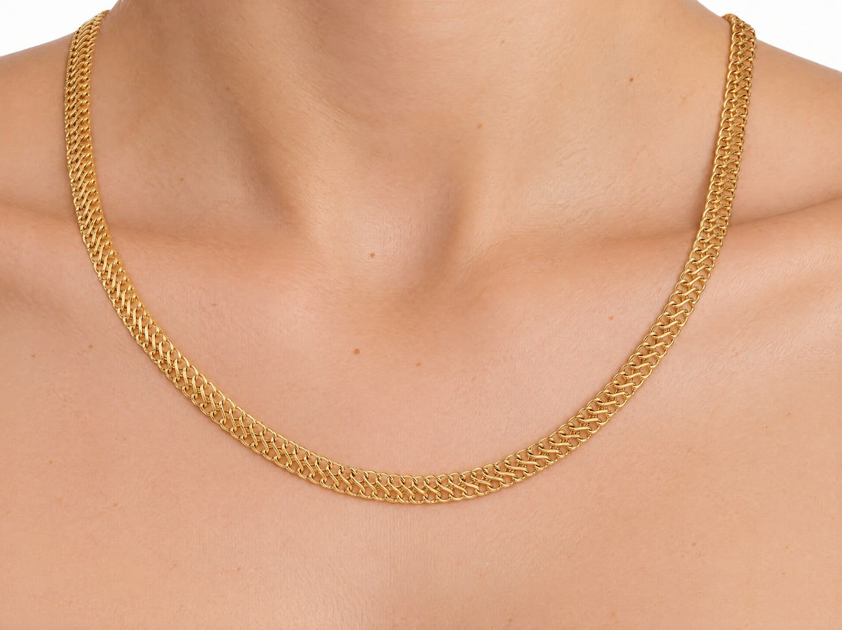 Woven gold chain necklace worn on the neck, front view