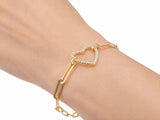 Gold heart bracelet worn on the wrist, seen from above