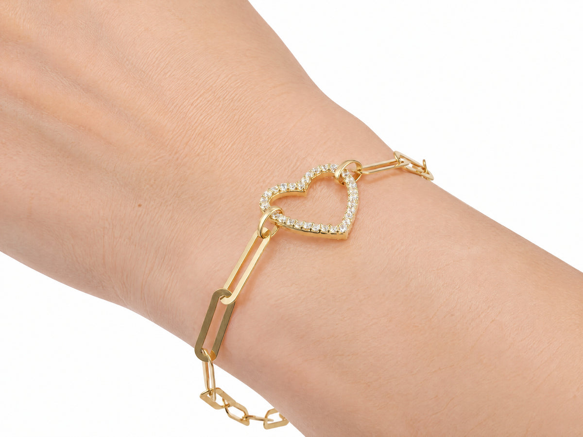 Gold heart bracelet worn on the wrist, seen from above