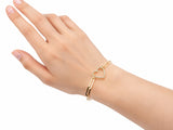 Gold heart bracelet worn on the hand, second view