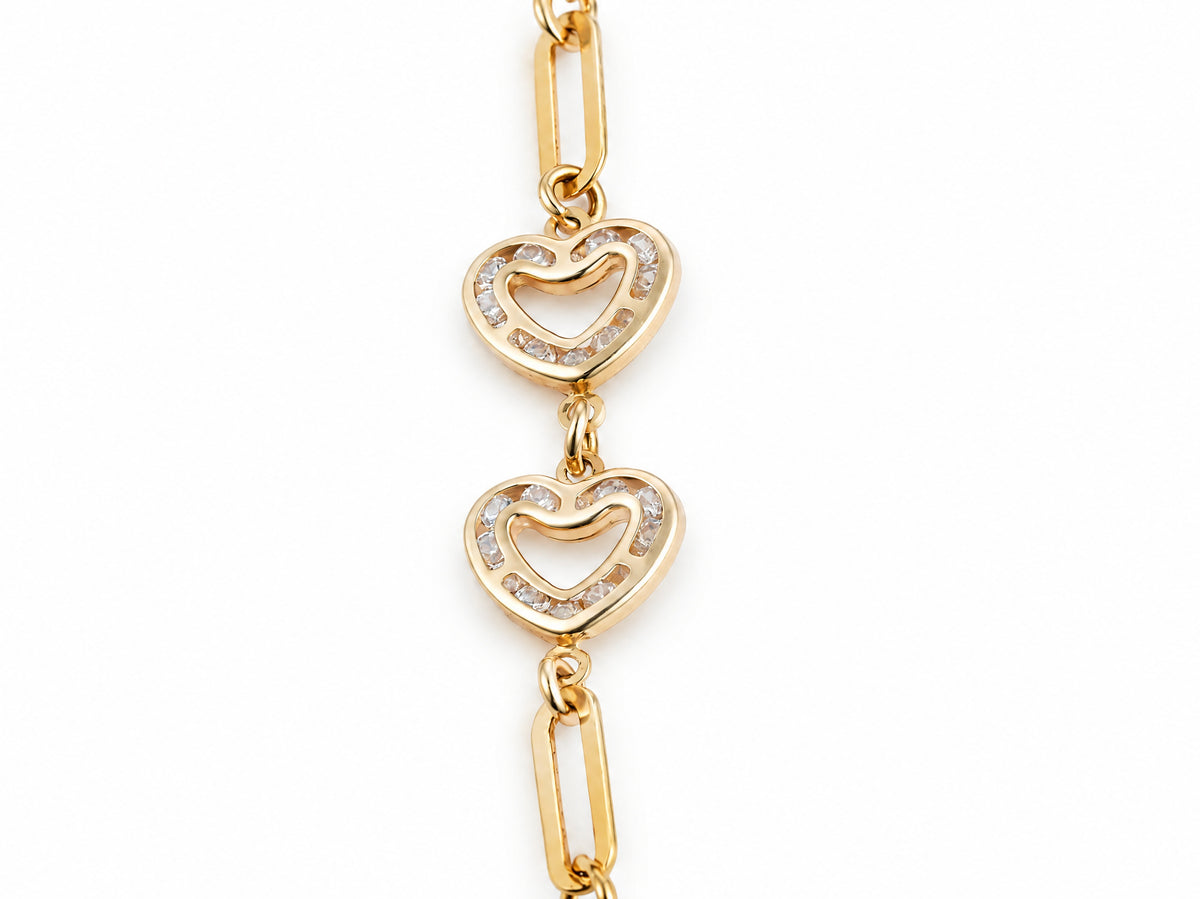 Close-up of two open heart links set with small cubic zirconia stones