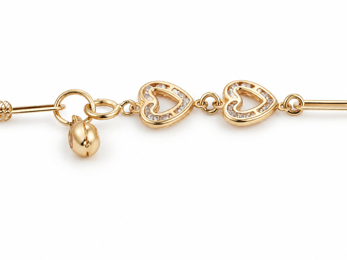 Macro detail of the toggle clasp on the gold heart link bracelet