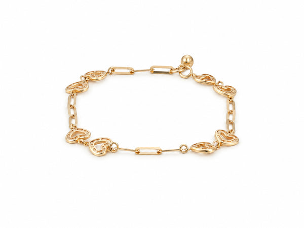 Gold heart link bracelet laid flat, alternating open heart and elongated links