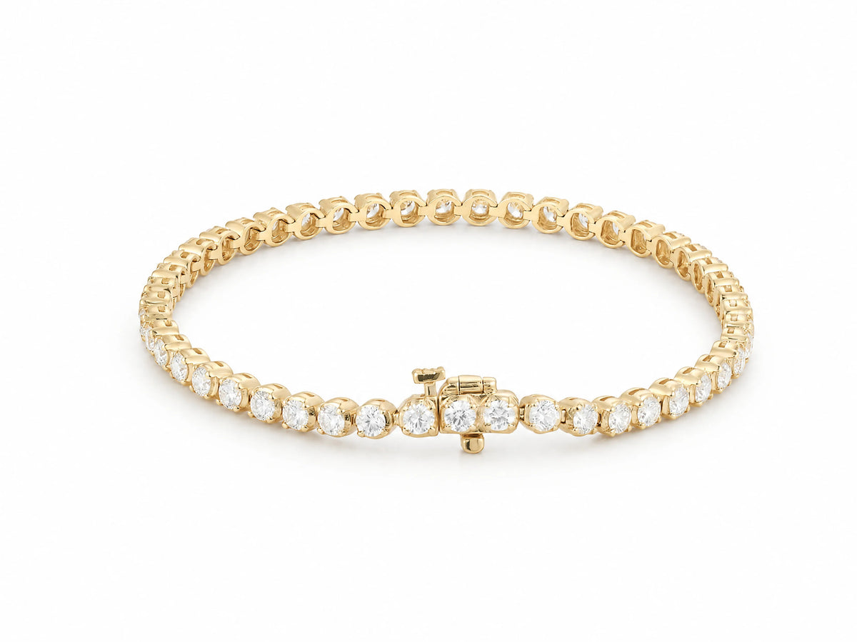 14K yellow gold tennis bracelet closed in an oval with the box clasp at the front, a single continuous row of round lab grown diamonds