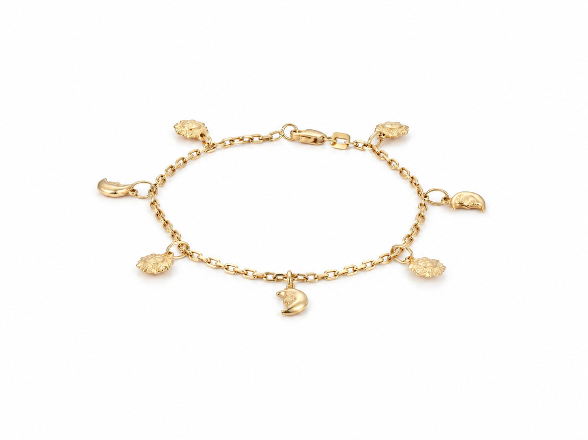 Gold charm bracelet shown full length with four sun charms and three crescent moon charms