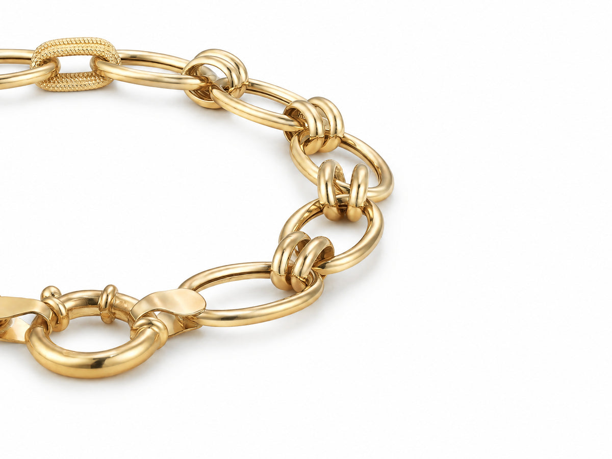 45 degree view of the gold bracelet with its oval links and connector rings