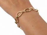 Gold bracelet worn on the wrist, side view of the oval links