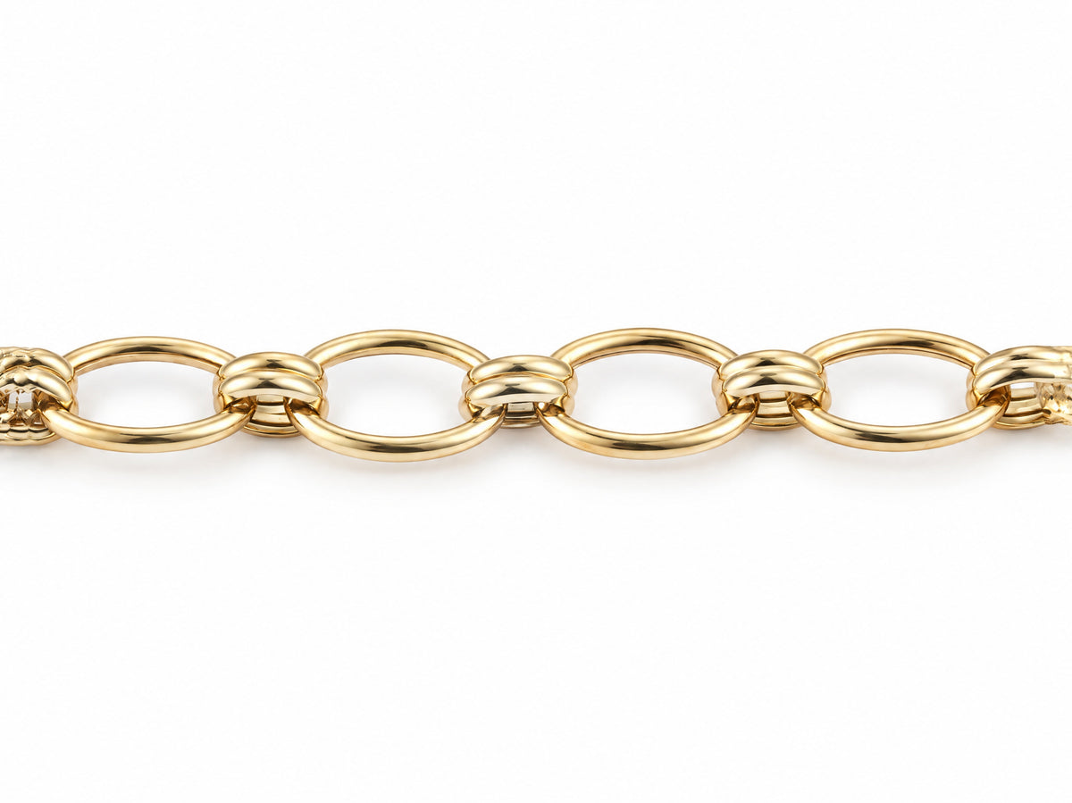 Overhead view of the gold bracelet with a row of oval links and double connectors