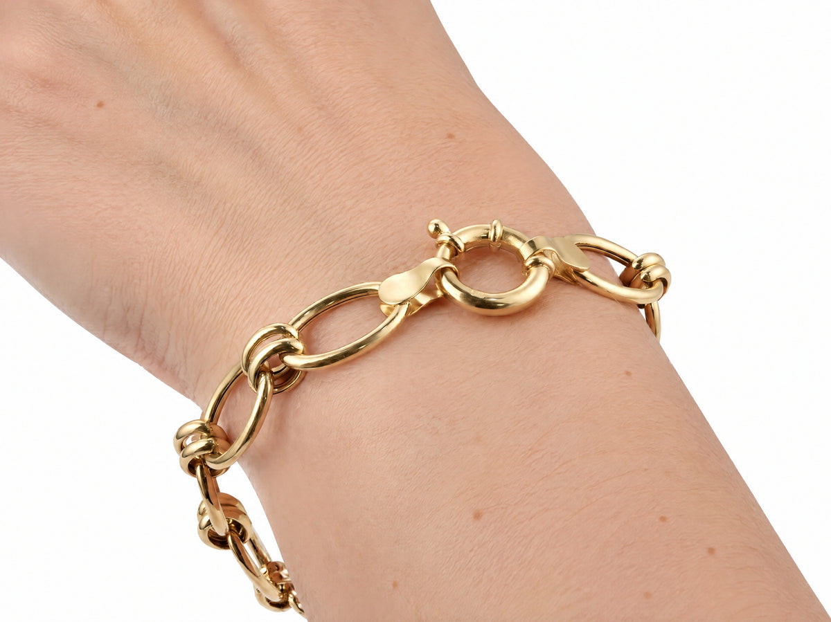 Gold toggle link bracelet worn on the wrist