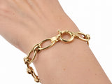 Gold toggle link bracelet worn on the wrist