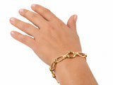 Gold toggle link bracelet worn on the wrist with the toggle ring visible