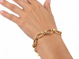 Gold toggle link bracelet worn on the wrist, hand extended