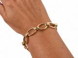 Gold toggle link bracelet worn on the wrist, forearm view