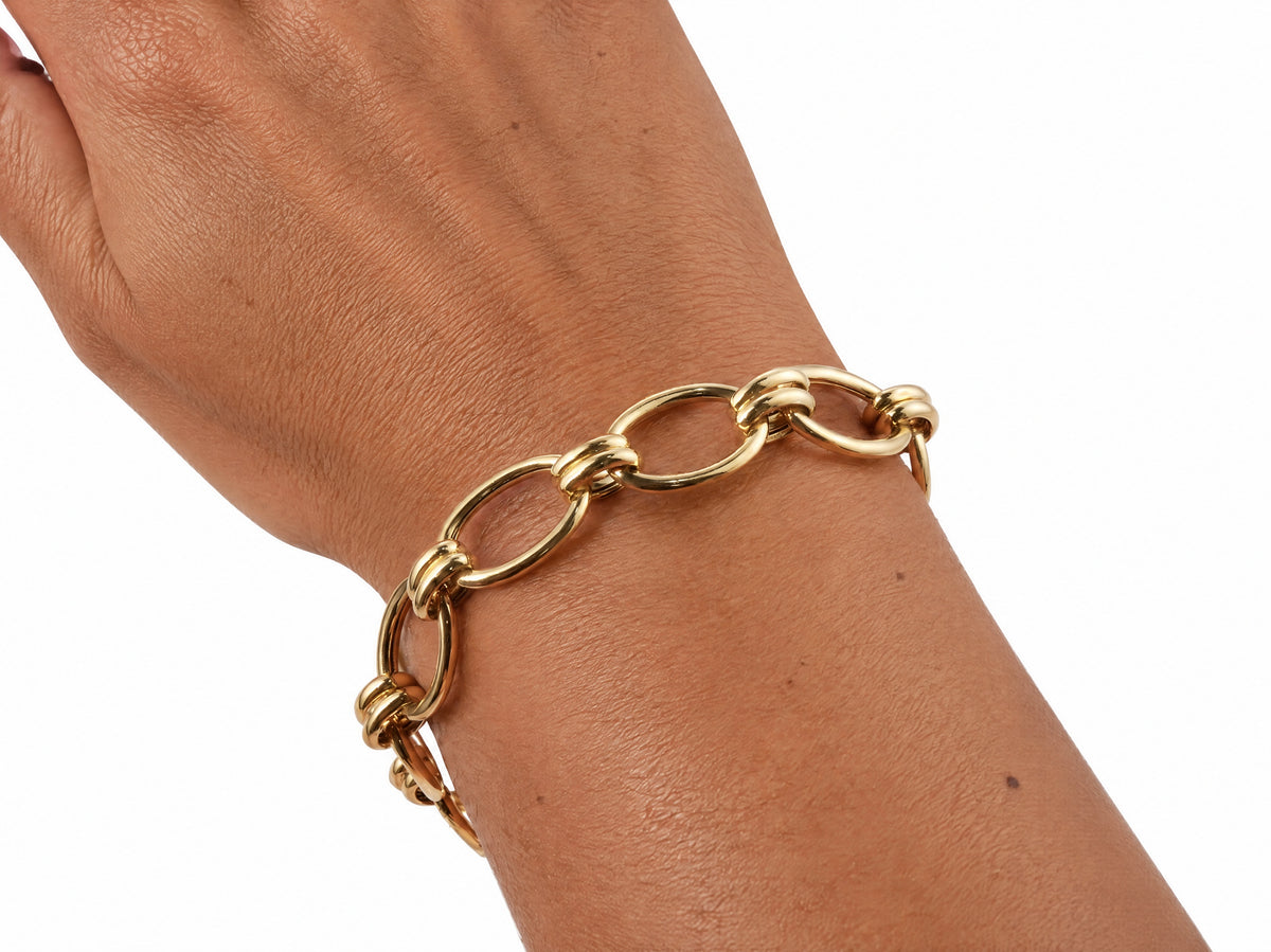 Gold toggle link bracelet worn on the wrist, forearm view