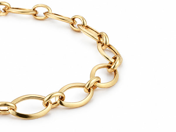 Close-up of the open oval links joined by small round links on the gold bracelet