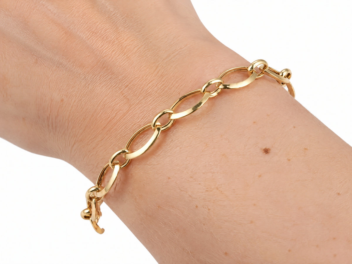 Gold heart lock bracelet worn on the wrist, view from above