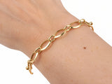 Gold heart lock bracelet worn on the wrist, view from above