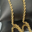 18k Gold Rope Chain with intricate pattern on display.
