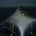 18k gold anklet with dazzling charm, securely set zirconias and beads