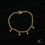 Shiny gold chain bracelet with five dangling spherical charms, perfect as an 18k gold bracelet for kids