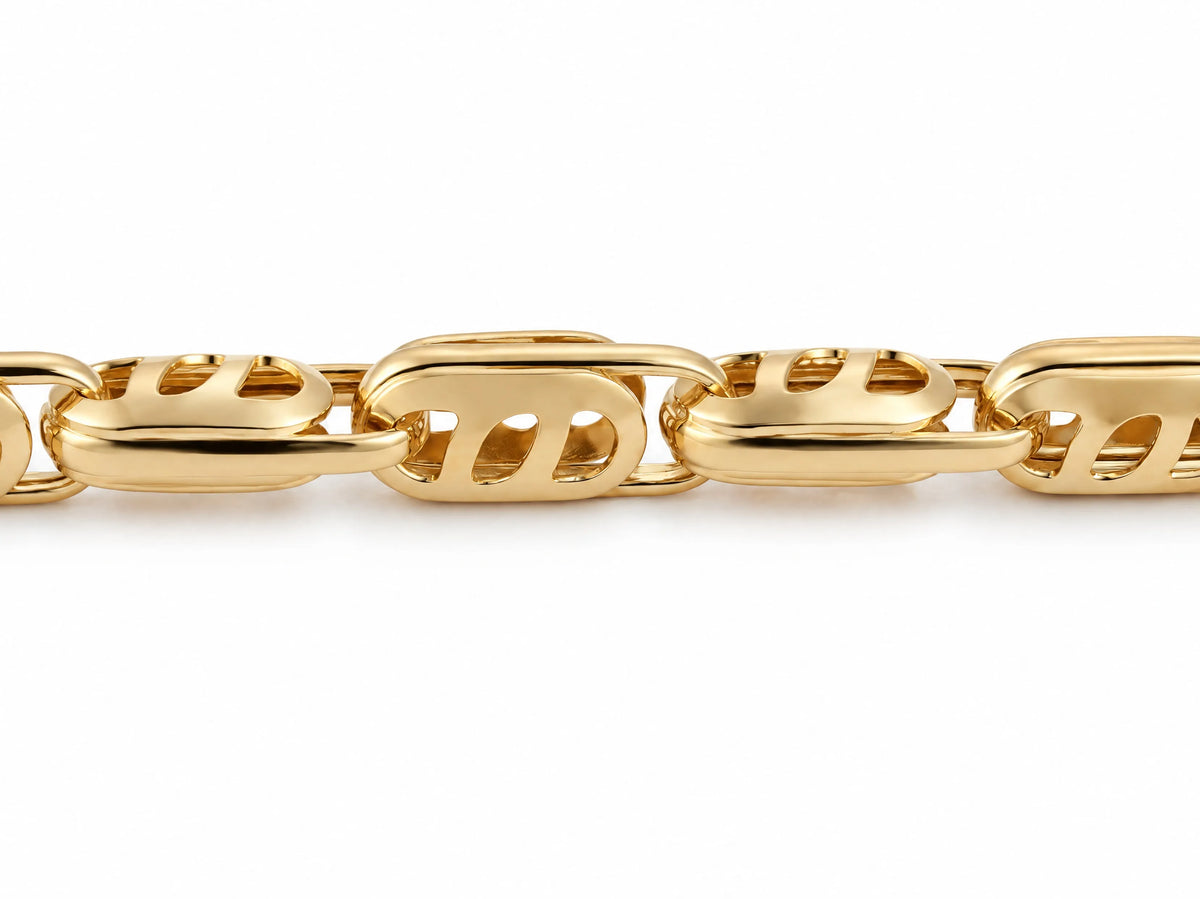 Close-up of the openwork cutout link pattern on an 18K yellow gold bracelet