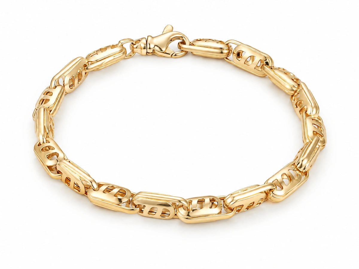 18K yellow gold bracelet with alternating solid bar and openwork links, laid flat on a white background