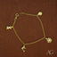 18k gold charm bracelet for kids with four dangling charms showcasing elegance and style