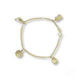 18k gold charm bracelet with dolphin, teddy bear, sun, and clover charms on white background