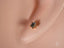 Gold star-shaped stud earring with dark gemstone in 18K Gold Jewelry collection
