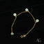 18k gold evil eye bracelet for kids featuring a gold chain with light blue charms