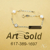 18k gold ID bracelet with pearls, diamond flower, and CZ black charm