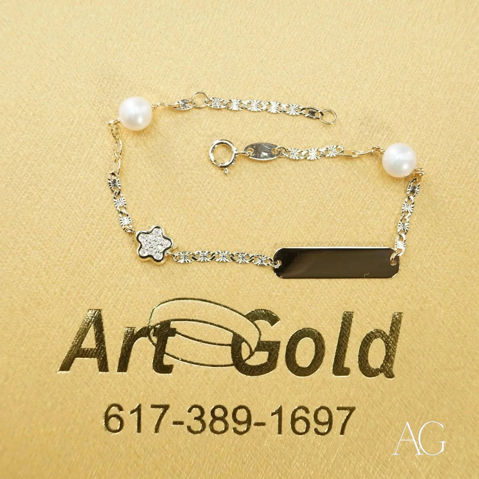18k gold ID bracelet with pearls, diamond flower, and CZ black charm