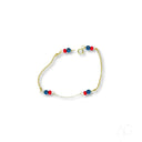 Child’s 18k gold bracelet with black coral and red blue beads