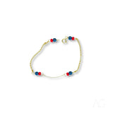 Child’s 18k gold bracelet with black coral and red blue beads