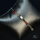 Child’s 18k gold ID bracelet with black coral and heart symbol