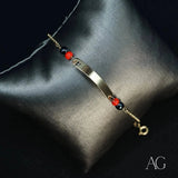 Child’s 18k gold ID bracelet with black coral and heart symbol