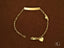 Gold bracelet with customizable ID plate, heart charm, and lobster clasp in solid 18k gold