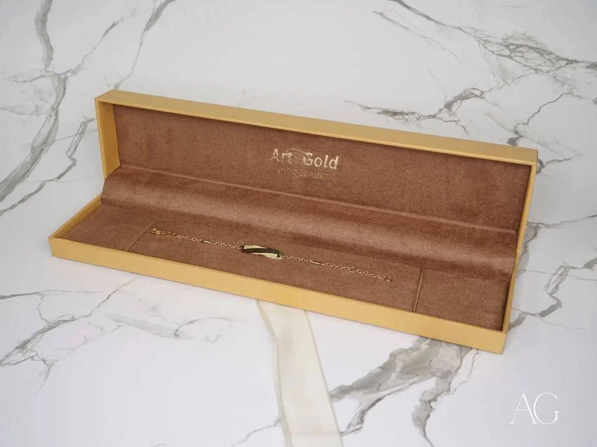 Open light brown jewelry box with 18k gold kid’s jaseron mesh ID bracelet