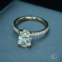 18k gold oval diamond engagement ring with pavé band