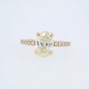 18k gold oval diamond engagement ring with pavé band
