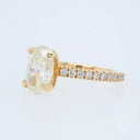 18k gold oval diamond engagement ring with pavé band