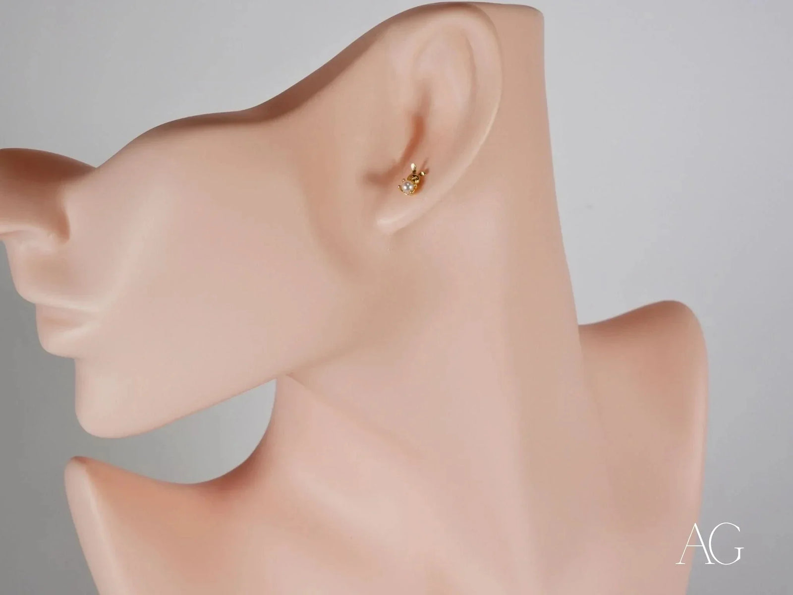 18k gold pearl stud earring with gemstone animal design