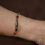 18k gold personalized bracelet with black coral beads and a gold bar design for kids
