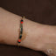Bracelet featuring 18k gold, black coral, and red and black beads for personalized style