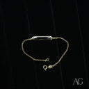 Child’s 18k gold personalized ID bracelet with polished rectangular bar on tiny wrists