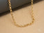 Delicate 18K solid gold rolo chain necklace showcasing classic round-link design in art gold jewelry
