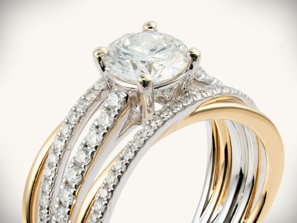 18K two-tone gold engagement ring with four-prong center diamond, close-up view