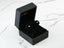 Open black jewelry box with velvet lining showcasing 18k white gold 4mm ball earrings